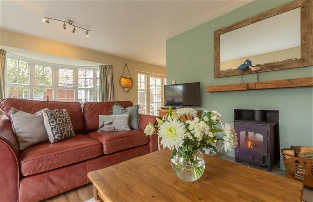Ground floor: Sitting room with wood burning stove at Forge Cottage, Thornham near Hunstanton