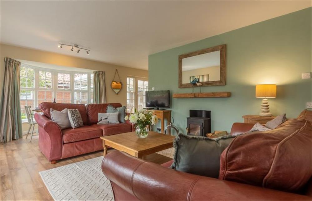 Ground floor: Sitting room with wood floors and lovely bay window at Forge Cottage, Thornham near Hunstanton