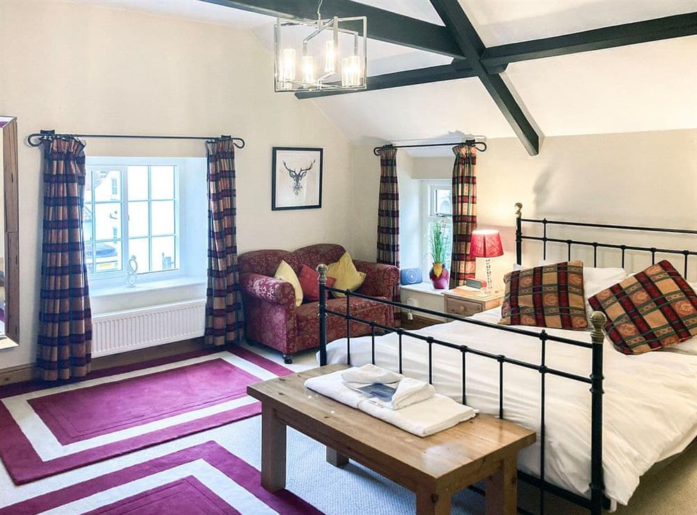 Cosy and inviting beamed double bedroom with kingsize bed at Forge View Cottage in Thornton-le-Dale, near Pickering, North Yorkshire