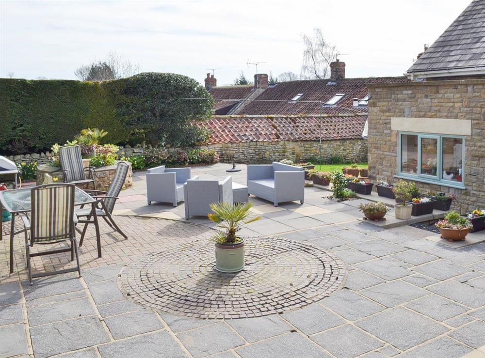 Large paved patio ideal for entertaining at Forge Villa in Ebberston, near Pickering, North Yorkshire