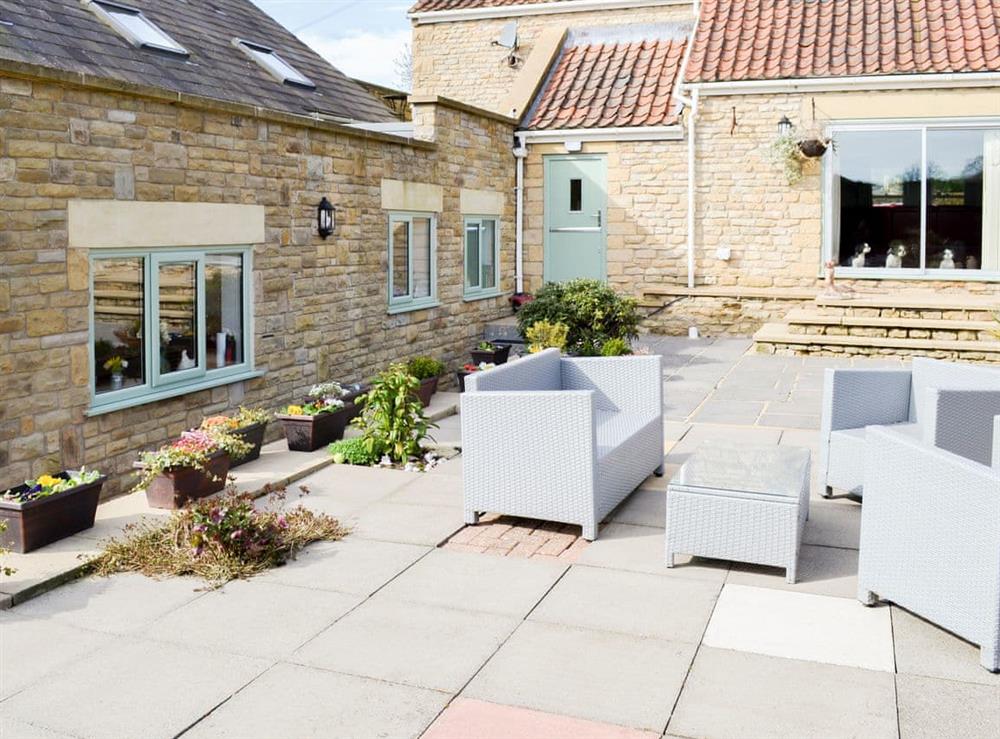 Paved patio with furniture at Forge Villa in Ebberston, near Pickering, North Yorkshire