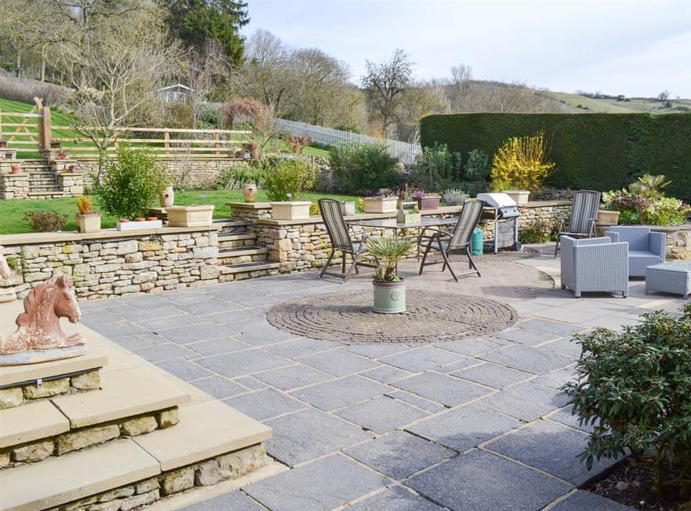 Spacious patio and lawned garden at Forge Villa in Ebberston, near Pickering, North Yorkshire