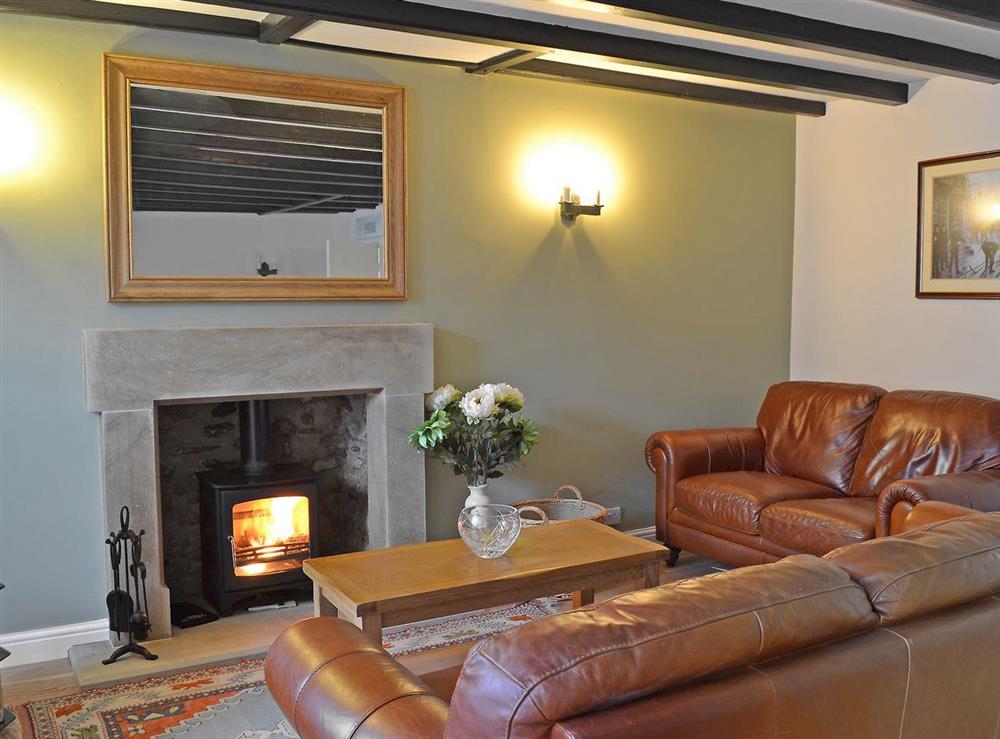 Comfortable beamed living room with multi-fuel burner and adjoining dining area at Four Seasons in Pickering, North Yorkshire