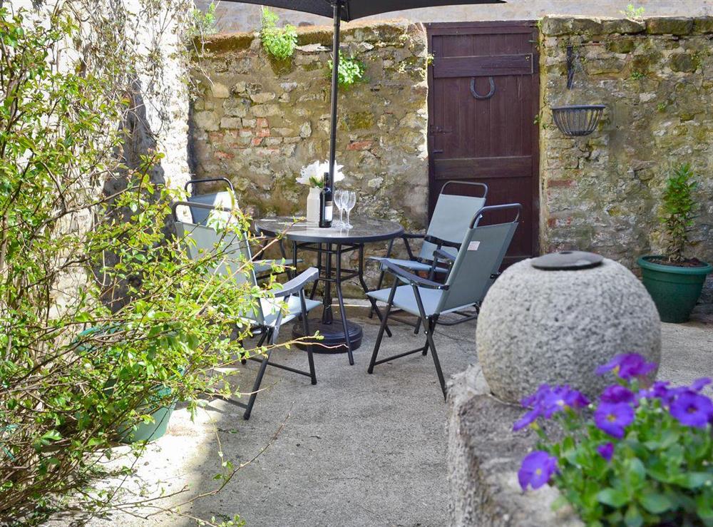Quaint enclosed courtyard with sitting-out area at Four Seasons in Pickering, North Yorkshire