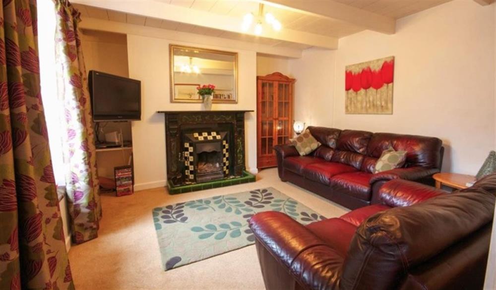 Sitting room with open fire at Fourways in Marazion