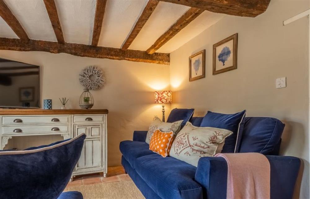 Ground floor: Sitting room with blue velvet sofas, cushions and throws at Fox Cottage, South Creake near Fakenham