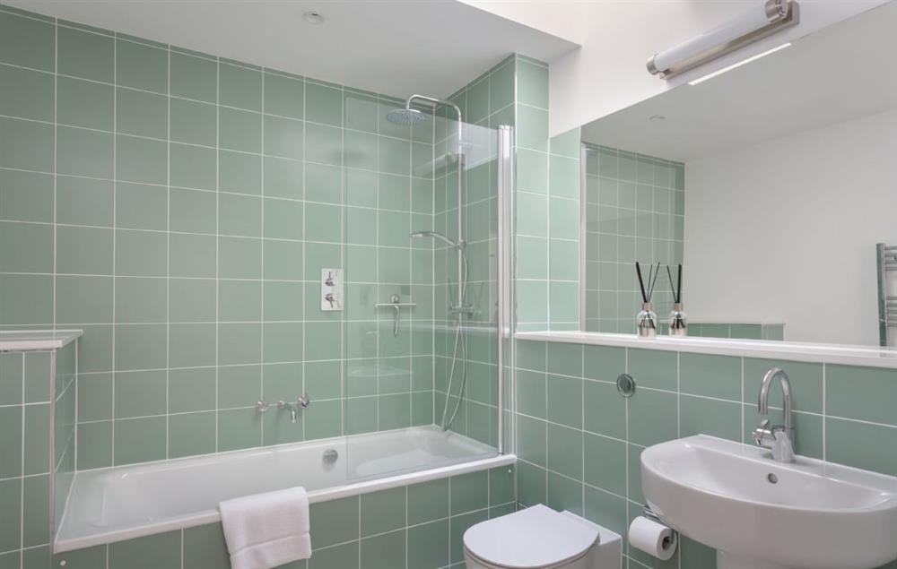 Bathroom with bath and shower over at Fox Hatch, Takeley