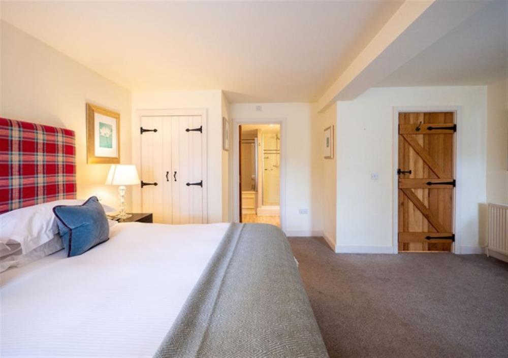 Bedroom 2 with built-in wardrobe and door to ensuite at Fox Tor in Chagford