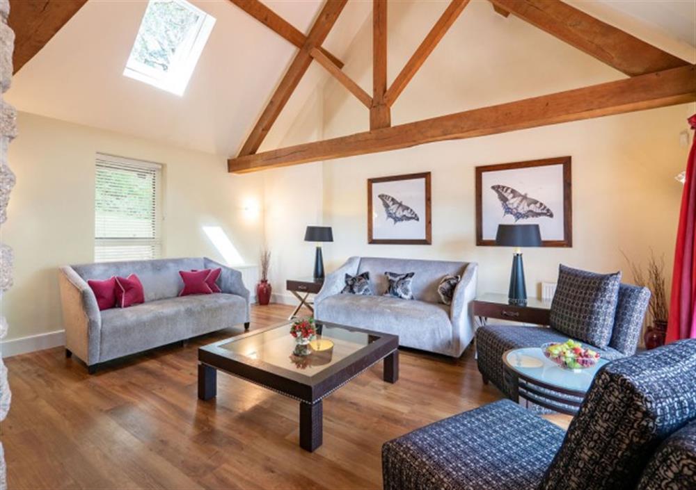 Bright sitting room with exposed beams at Fox Tor in Chagford