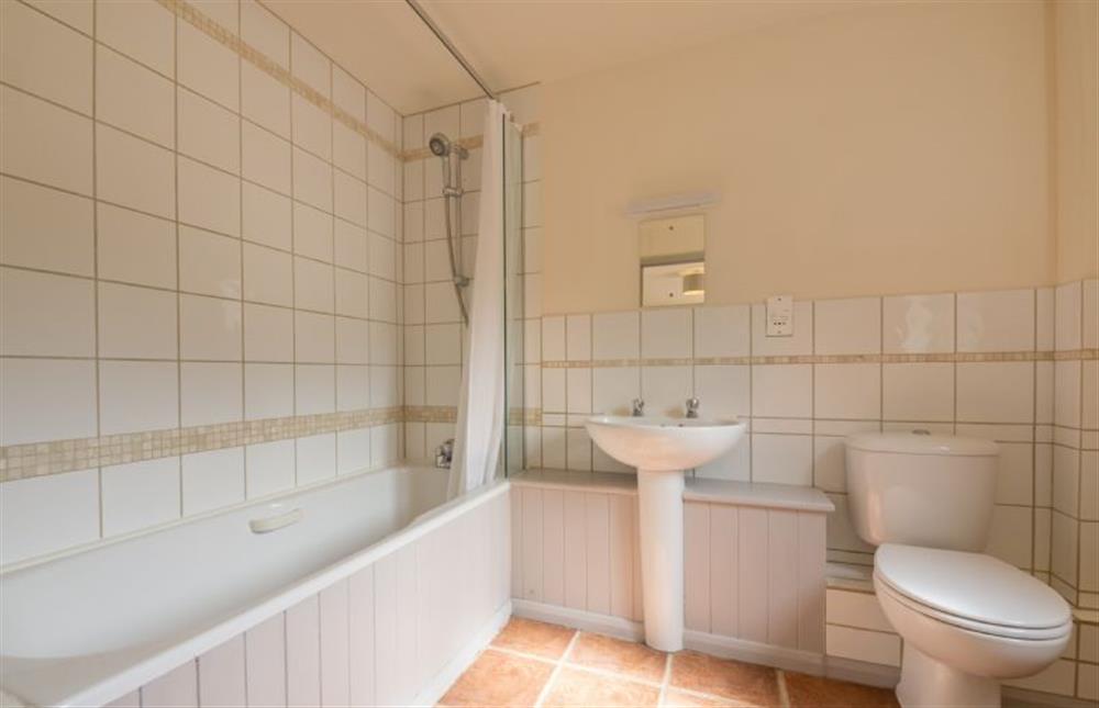 Bathroom:  Bath with shower over at Foxglove, Houghton near Kings Lynn