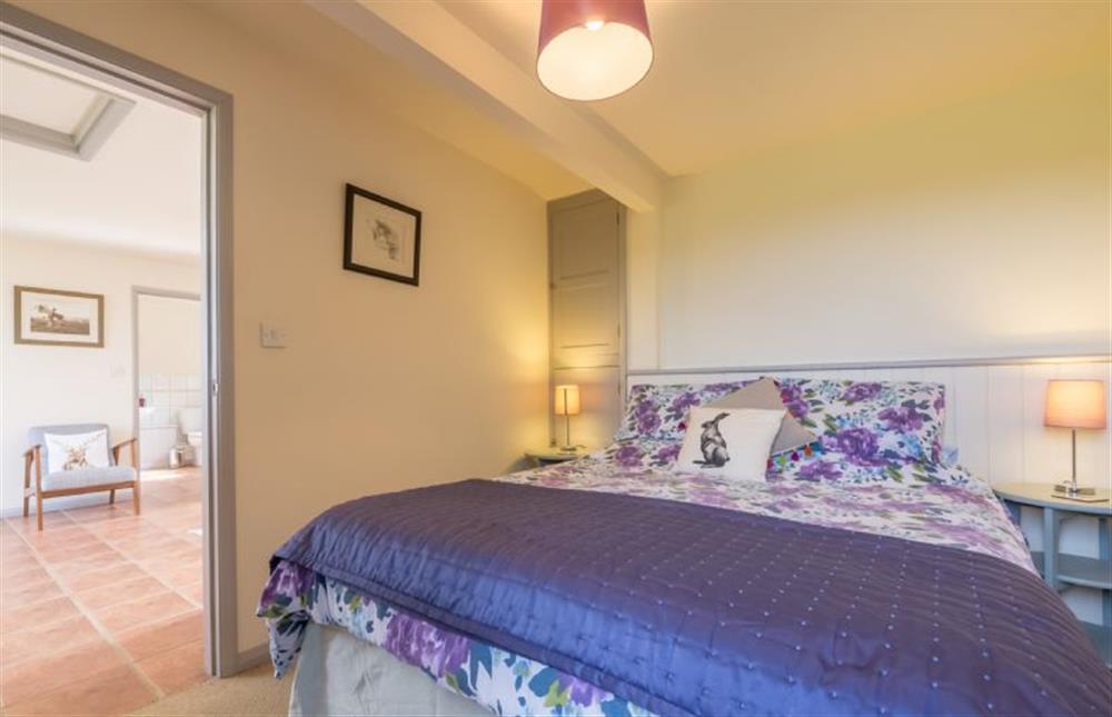 Ground floor:  Bedroom with king-size bed and door to sitting/dining room at Foxglove, Houghton near Kings Lynn