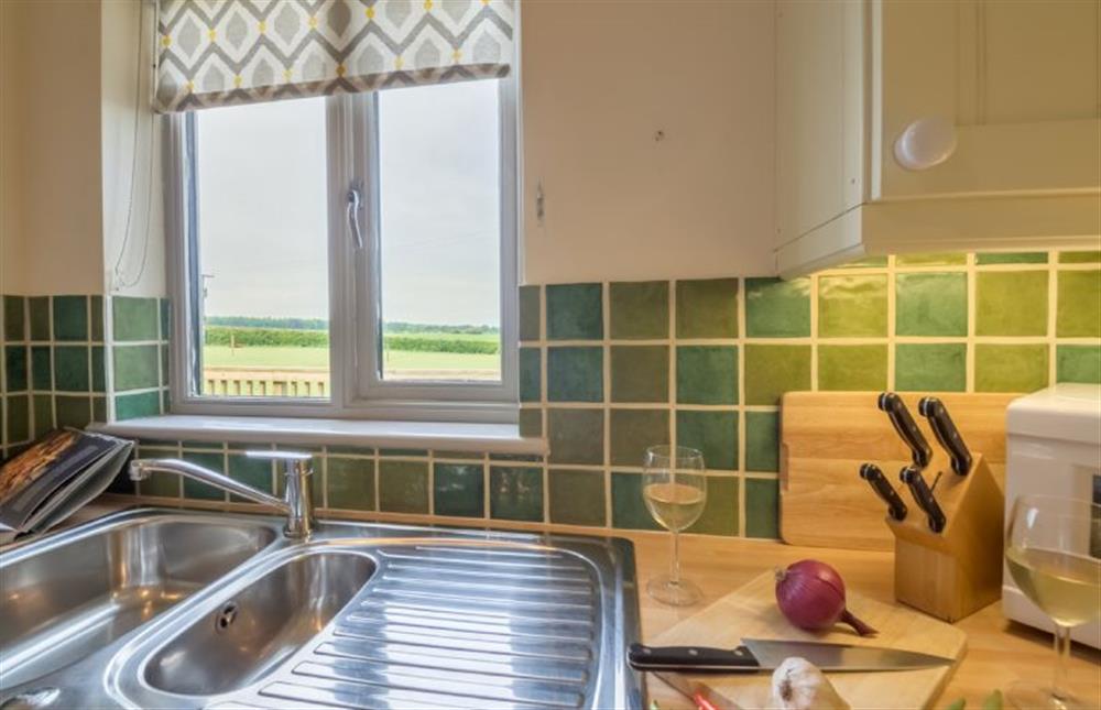 Ground floor:  Kitchen with window overlooking fields at Foxglove, Houghton near Kings Lynn