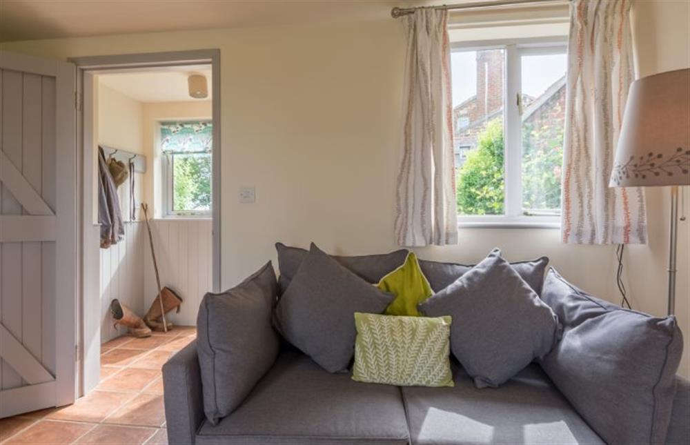 Ground floor:  Sitting/dining room with comfy sofa at Foxglove, Houghton near Kings Lynn