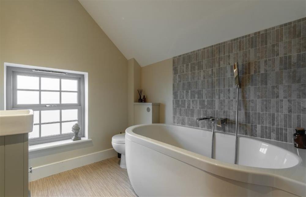First floor: Bathroom with oval bath tub and hand-held shower at Foxhill House, South Creake near Fakenham
