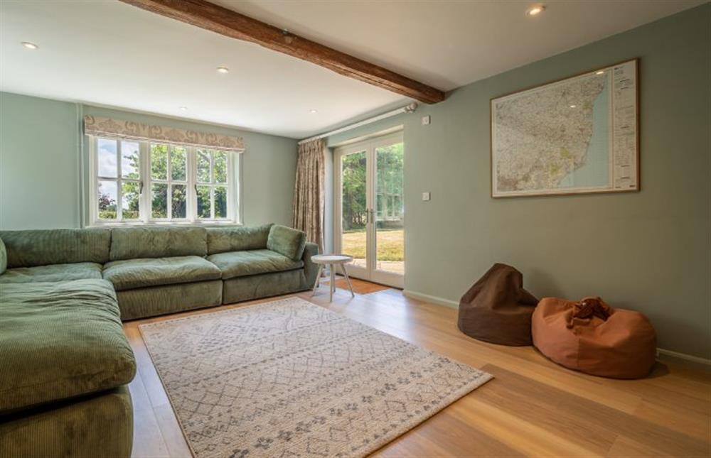 Television room with large corner sofa at Foxhole Cottage, Framsden