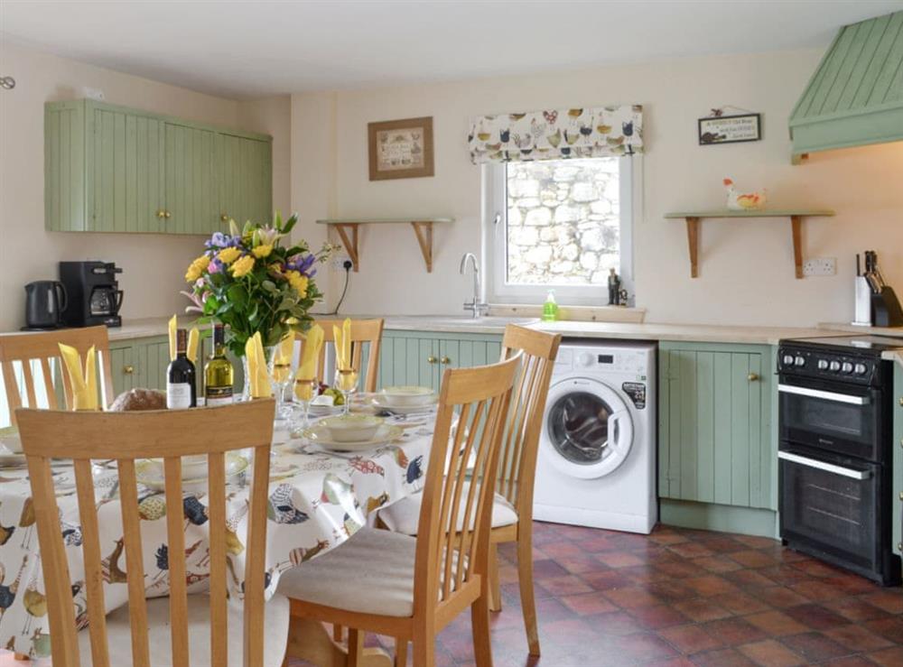 Well-equipped kitchen with dining area at Foxhole Farm Cottage in Beauly, Inverness-Shire
