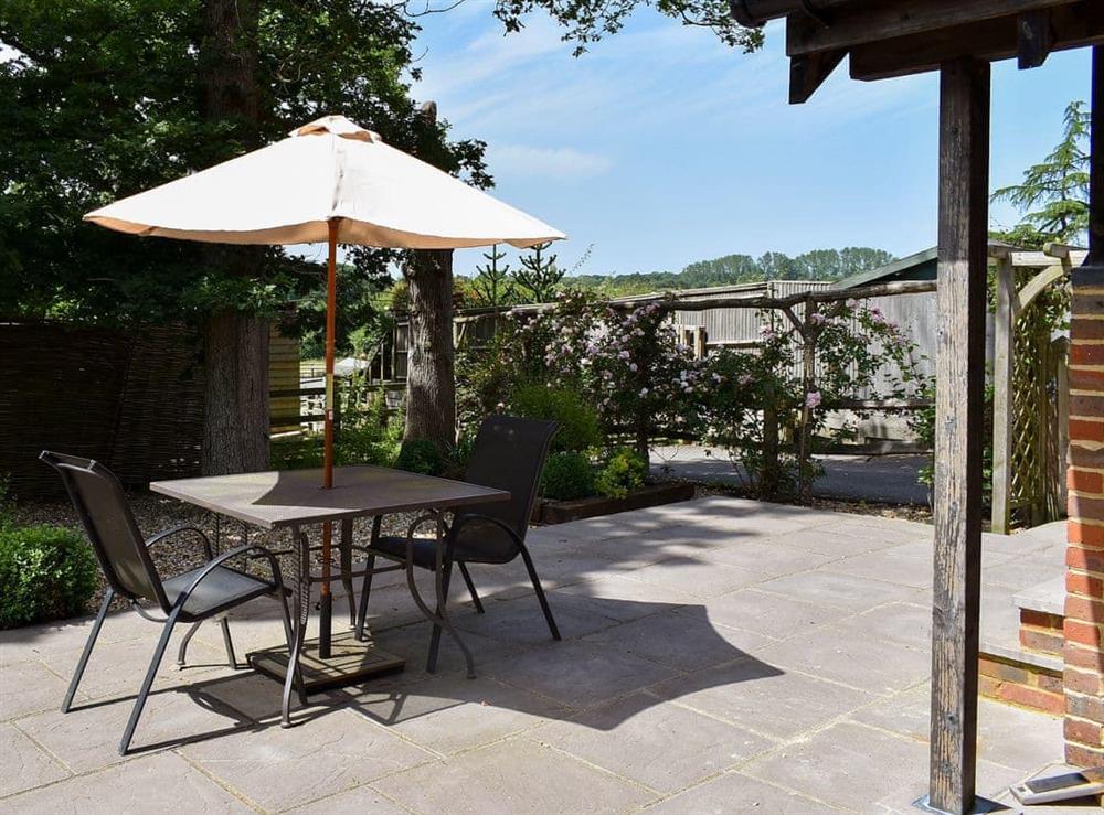 Large enclosed garden with patio and garden furniture at The Coop, 
