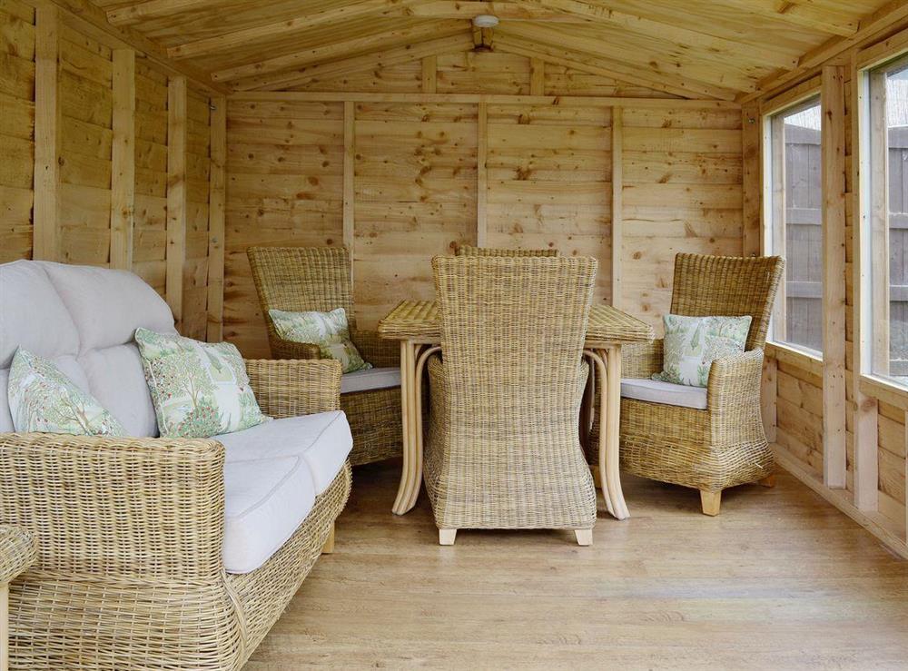 The summerhouse is well furnished at Frankcot in Llandudno, Gwynedd