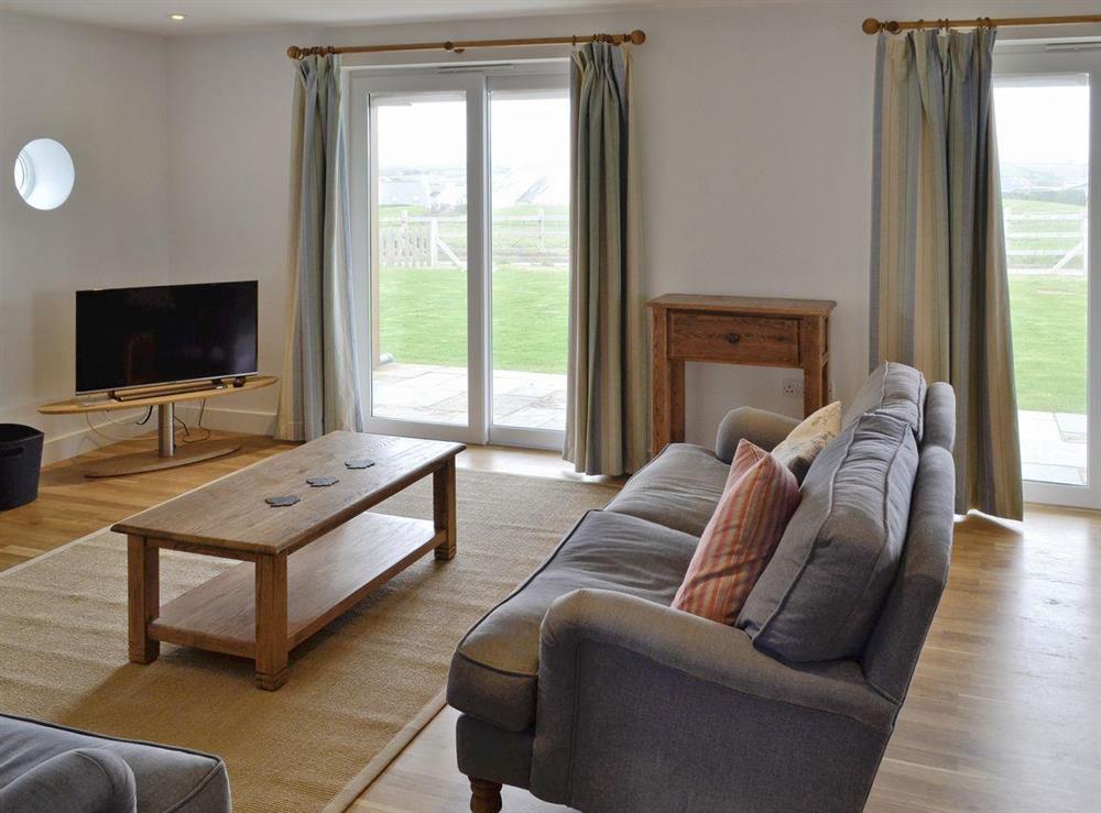 Attractive living and dining room with patio door access garden at Freefolk in Polzeath, Cornwall