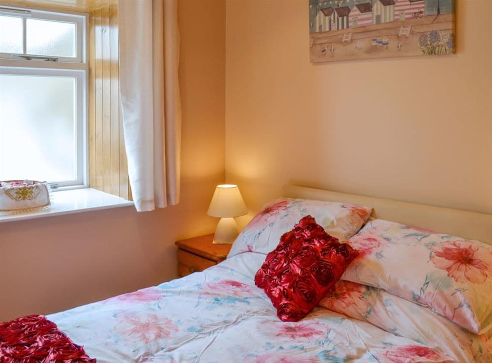 Warm and inviting double bedroom at Freya Cottage in Flamborough, North Humberside
