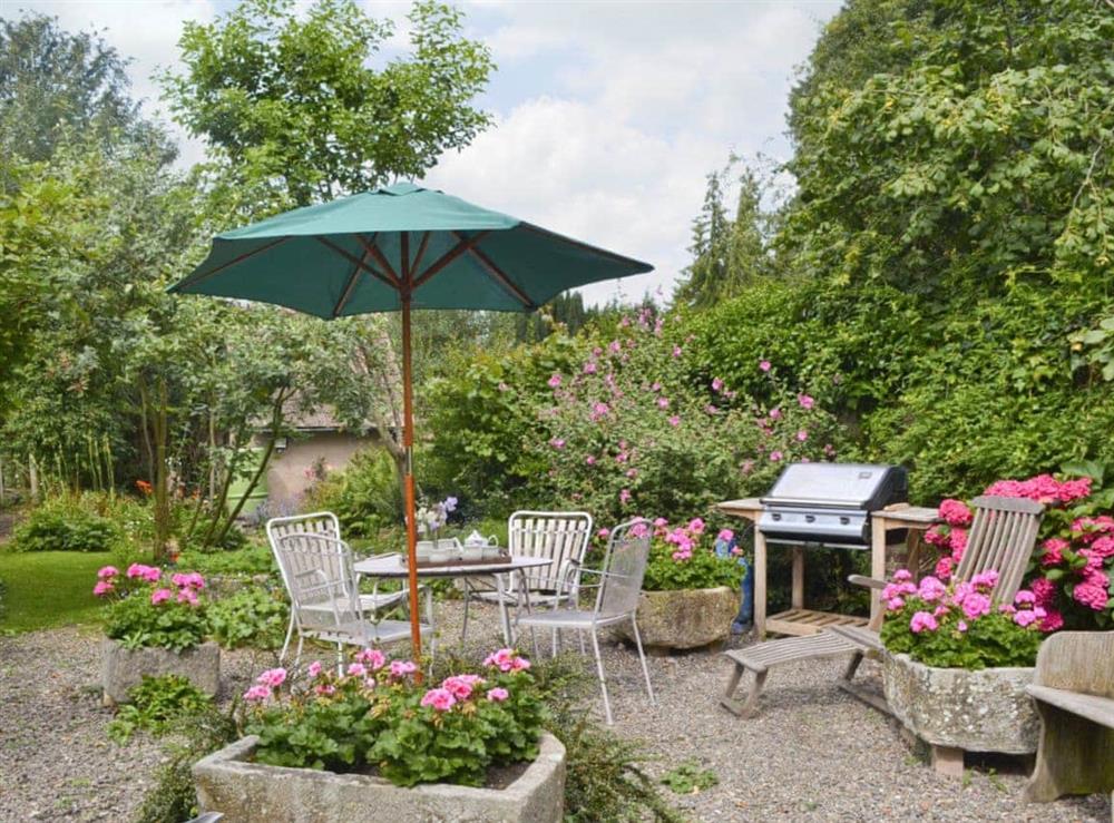 Delightful mature garden with outdoor furniture at Friary Cottage in Ludlow, Shropshire