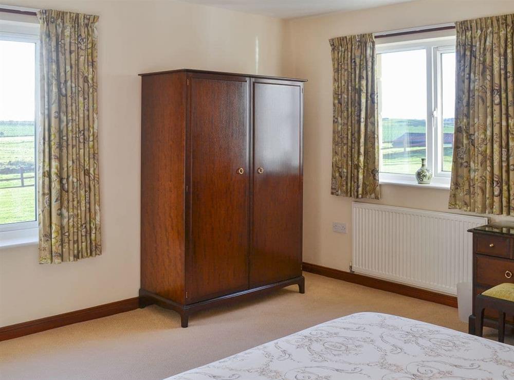 Bedroom with dual aspect views at Friarystone Cottage in Bamburgh, Northumberland., Great Britain