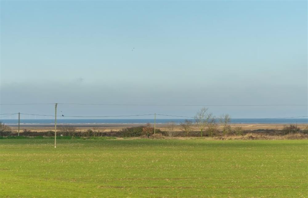Views to the marsh and sea beyond at Froggy Cottage, Thornham near Hunstanton
