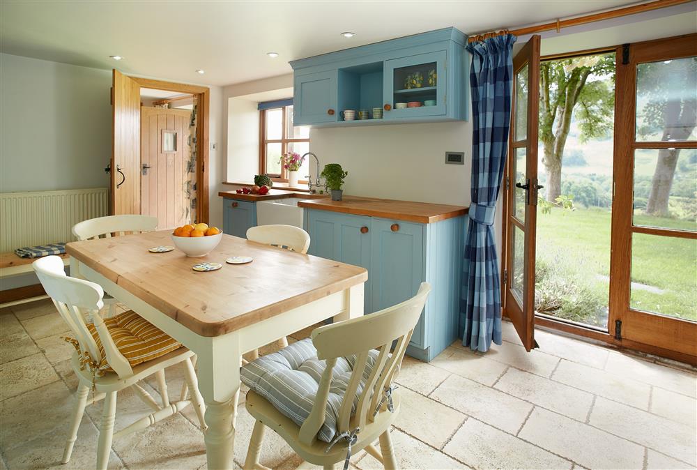 Ground floor: Kitchen with french doors leading out into the beautiful garden and far reaching views at Fron Cottage, Llangynog, Oswestry