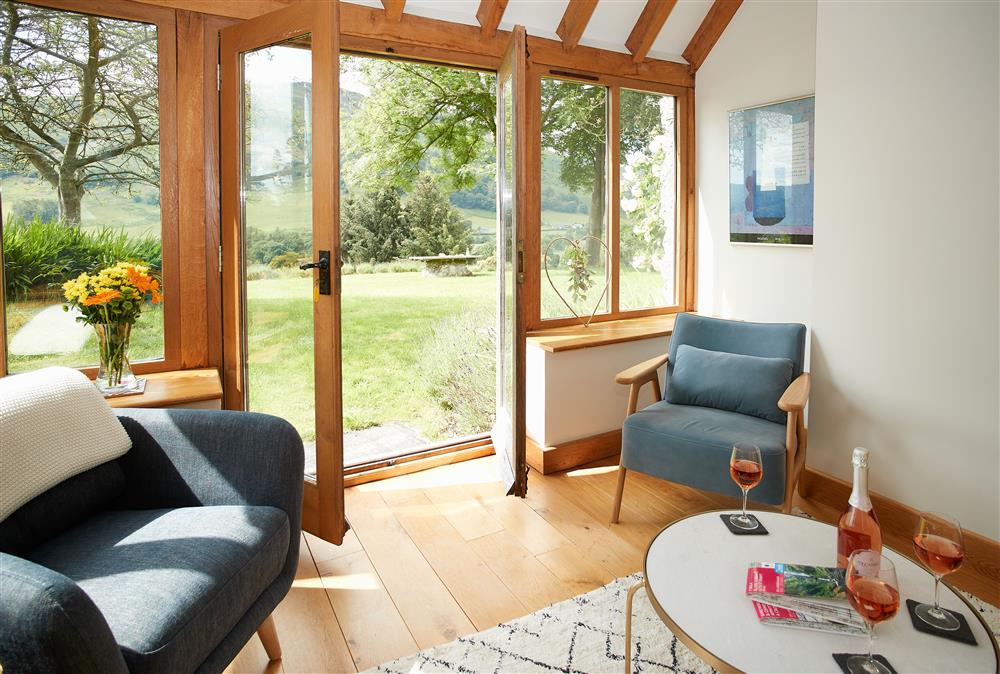 Ground floor: Oak room with french doors opening out to the delightful garden at Fron Cottage, Llangynog, Oswestry