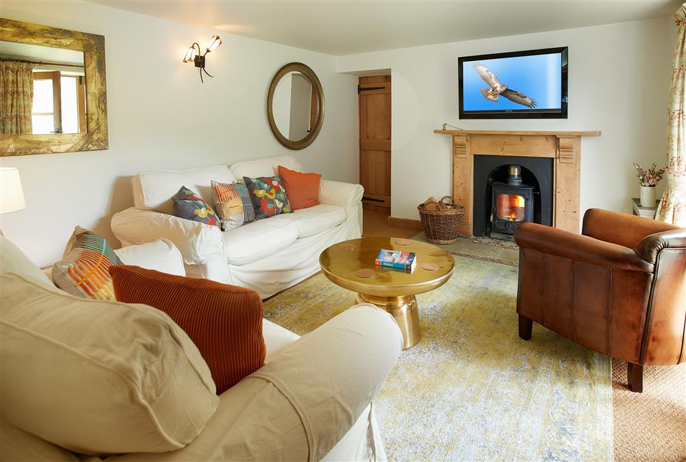Ground floor: Sitting room with cosy wood burning stove at Fron Cottage, Llangynog, Oswestry