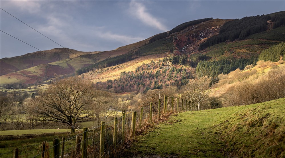 The countryside around Fron Dirion, with a waterfall in the distance, Powys at Fron Dirion in Dinas Mawddwy, Powys