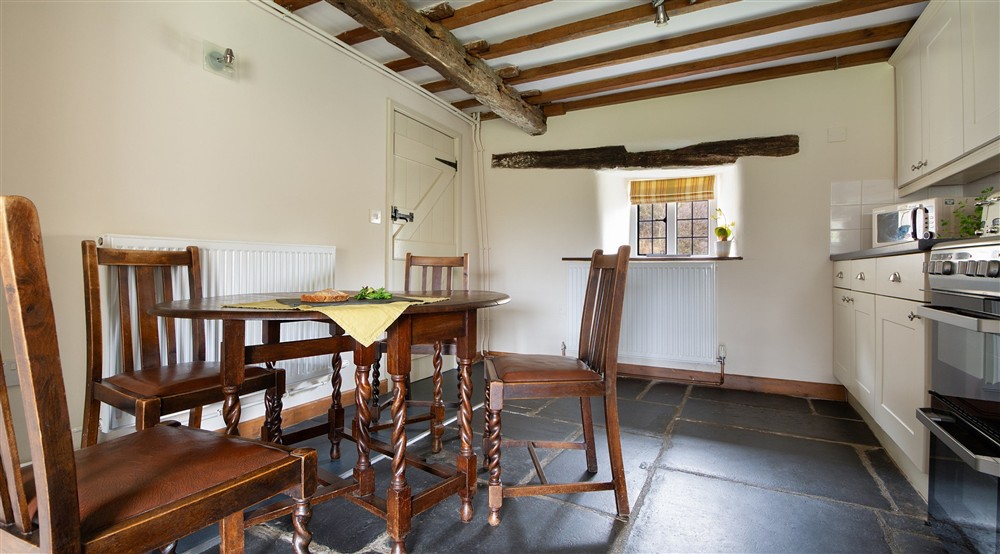 The dining table for four in the kitchen at Fron Dirion in Dinas Mawddwy, Powys
