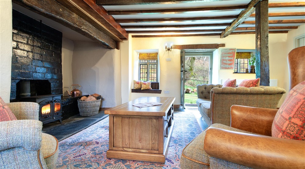 The sitting room with woodburner at Fron Dirion in Dinas Mawddwy, Powys