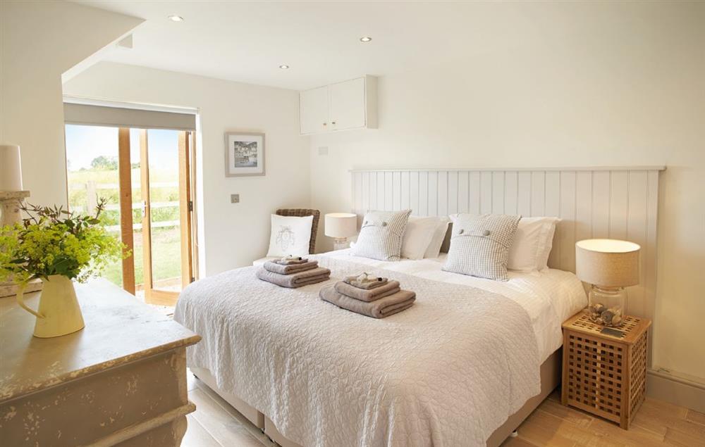Double bedroom with 6’ zip and link bed and en-suite shower room at Furlong Barn, Long Itchington