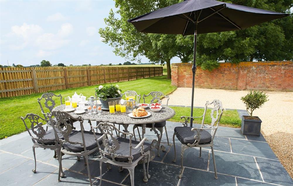 Mostly walled gravelled courtyard with a raised slate terrace area leading off from the kitchen. Lawned areas around the barn and beyond the courtyard wall