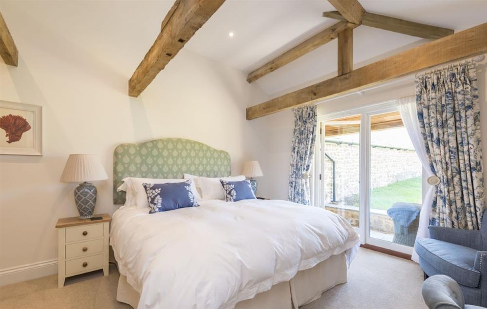 Bedroom one with super-king size bed and en-suite bathroom with bath and separate shower at Furlongs, Abbotsbury
