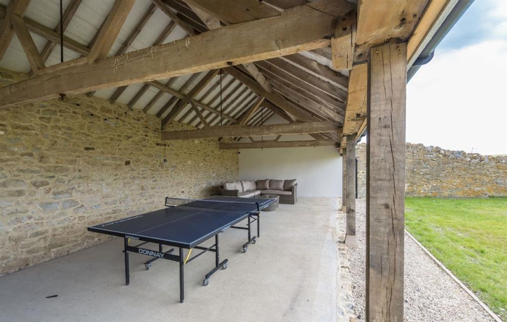 Covered area with table tennis and outdoor sofas, perfect for summer barbecues at Furlongs, Abbotsbury