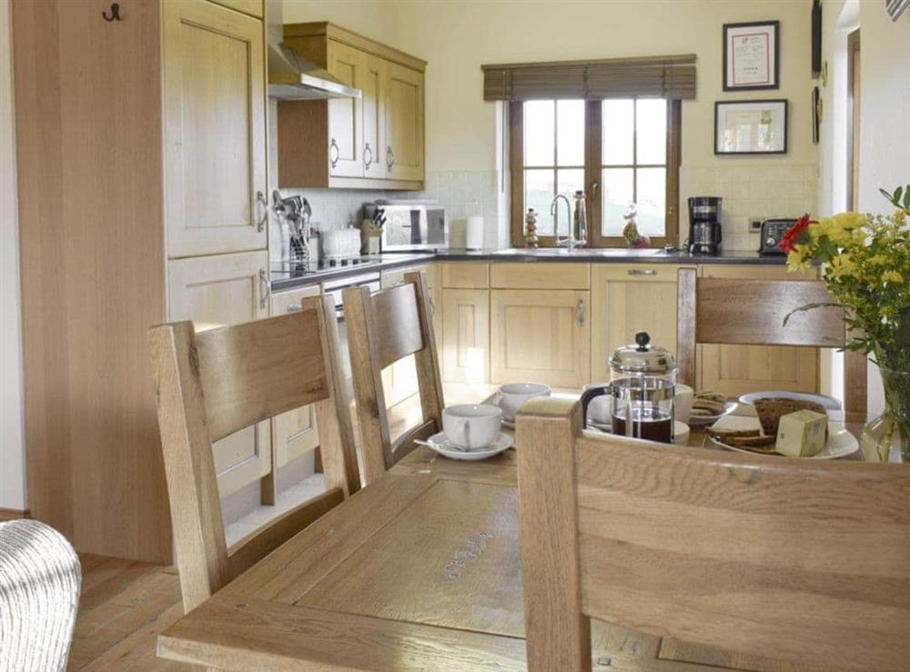 Dining area sits between living area and kitchen at Gwel-Y-Llyn, 