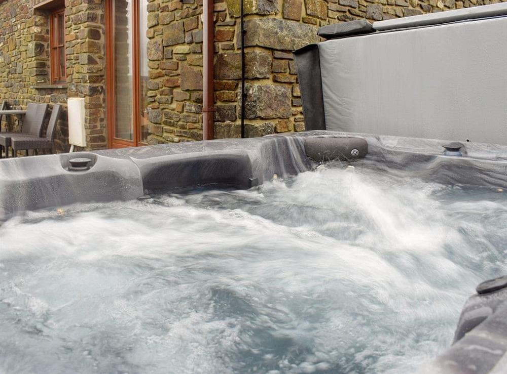 Luxurious hot tub on the patio at Tan Y Dderwen, 