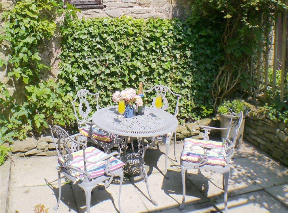 Enclosed courtyard with outdoor furniture at Gable Cottage in Leek, Staffordshire
