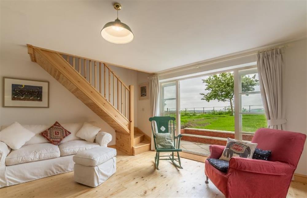 Ground floor:  Sitting area with comfy sofa and french doors to garden at Gallery Cottage, Wighton near Wells-next-the-Sea