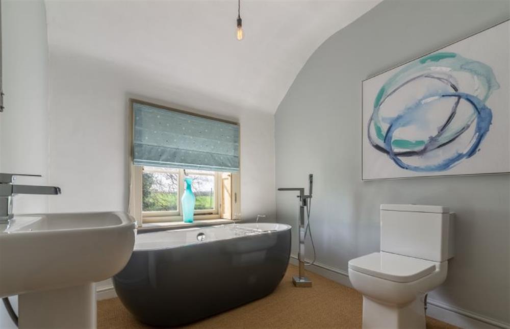 First floor:  Bathroom with high ceiling, wash basin and WC at Gamekeepers Lodge, South Raynham near Fakenham