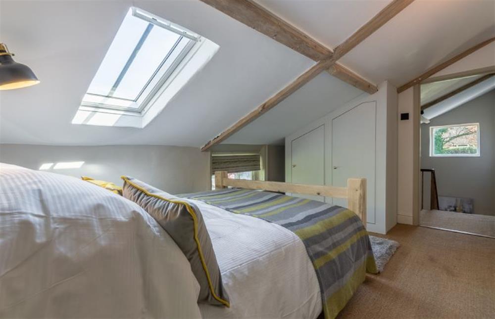 First floor:  Bedroom two with beamed ceiling (restricted head height) at Gamekeepers Lodge, South Raynham near Fakenham