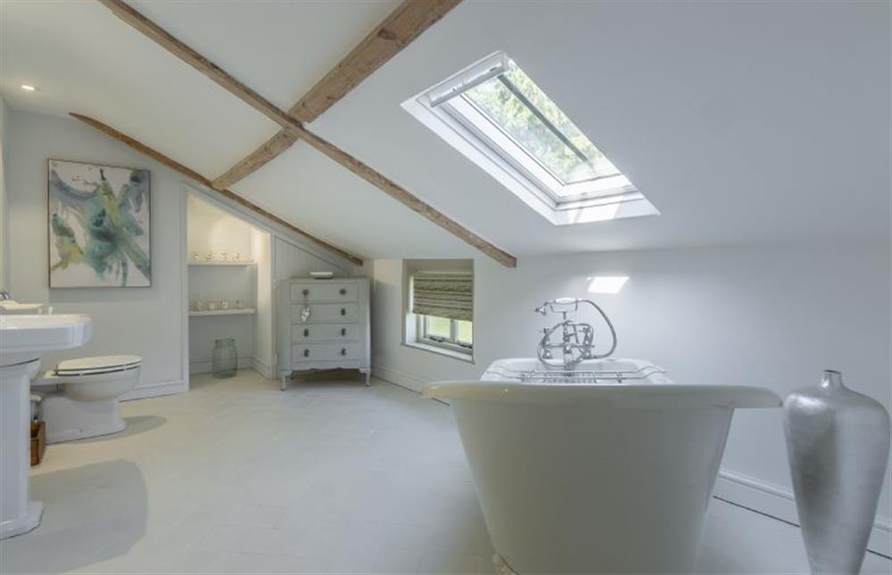 First floor:  En-suite bathroom with beamed ceiling (restricted head height) at Gamekeepers Lodge, South Raynham near Fakenham