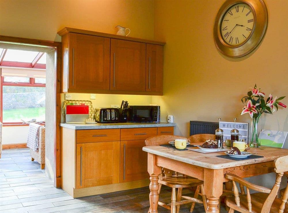 Fully-equipped kitchen with conservatory access at Garden Cottage in Coldingham, near Eyemouth, Berwickshire