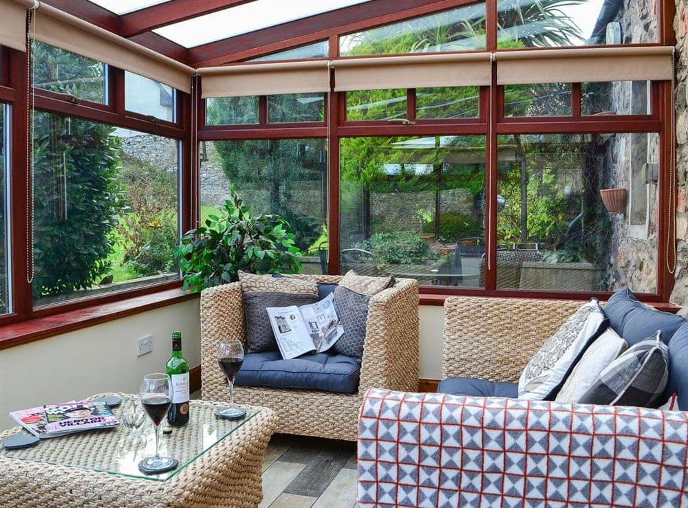 Relax in the warm and welcoming conservatory at Garden Cottage in Coldingham, near Eyemouth, Berwickshire