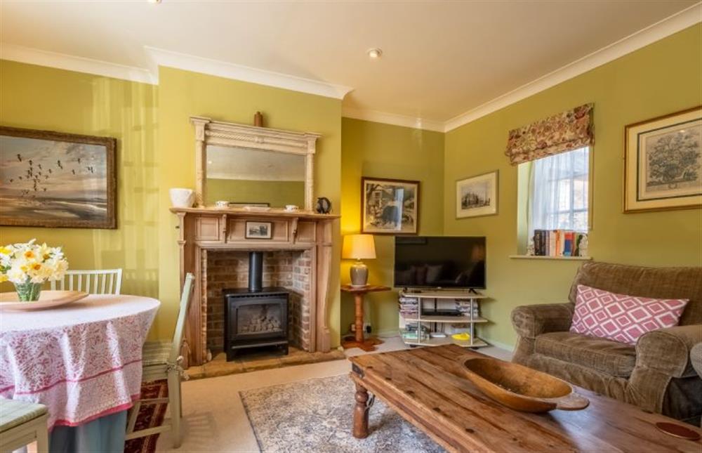 Garden Cottage:  Sitting room with plenty of comfortable seating and a wood burning stove  at Garden Cottage, East Rudham near Kings Lynn