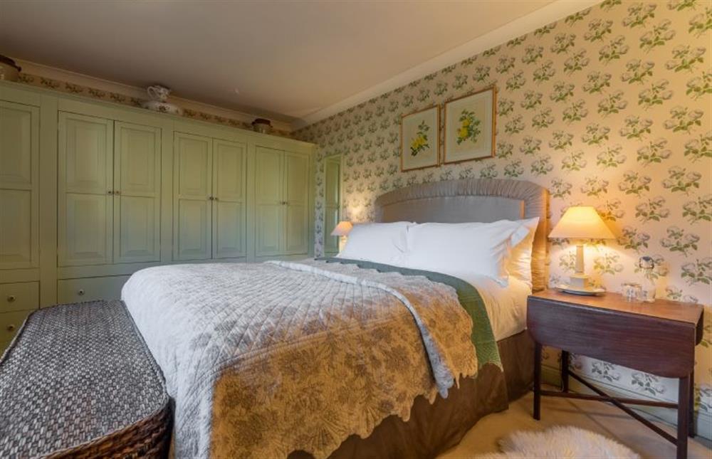 Ground floor: Master bedroom with king-size bed and fitted wardrobes at Garden Cottage, East Rudham near Kings Lynn