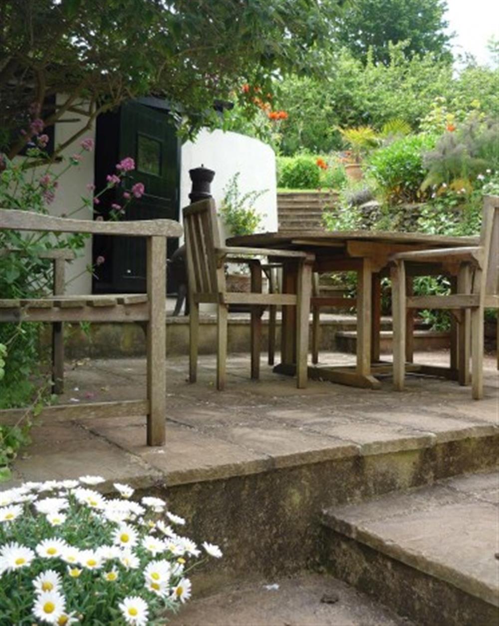 The patio, perfect for al fresco dining..... at Garden Cottage Hope Cove in Hope Cove