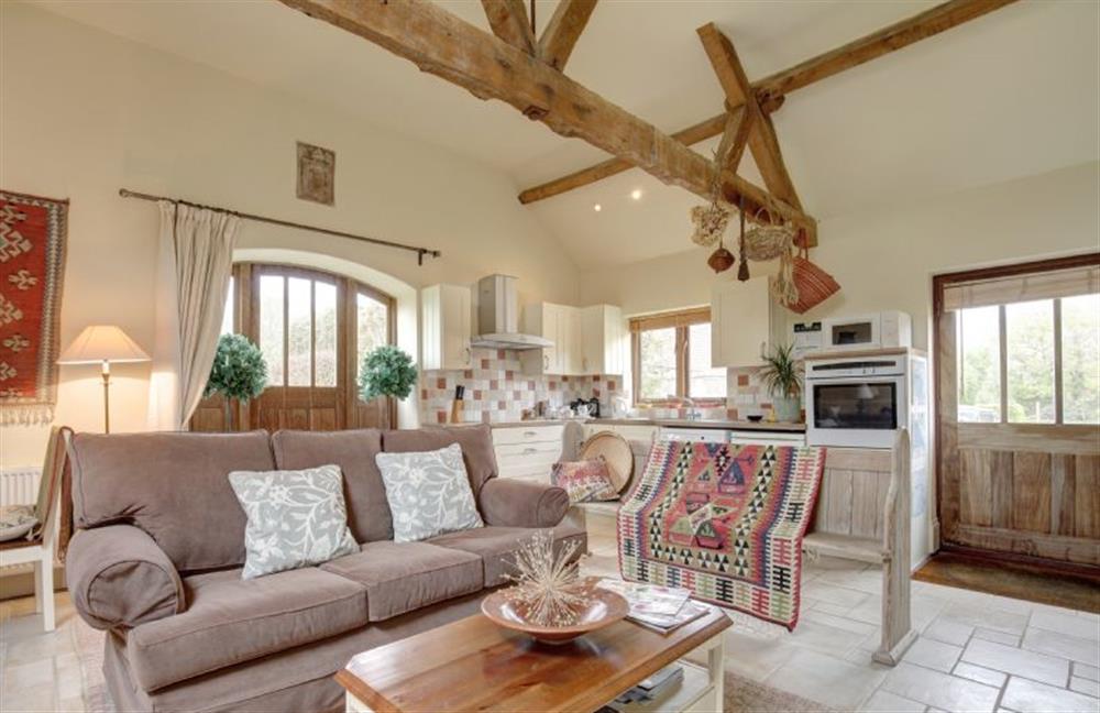 Ground floor:  Sitting area with comfy sofa and feature bench at Garden Cottage, Manor House Farm, Wellingham near Kings Lynn